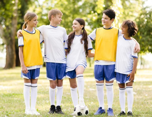 front-view-kids-in-football-sportswear-looking-at-each-other